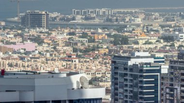 Birleşik Arap Emirlikleri 'nin finans bölgesindeki gökdelenden Dubai' deki apartman ve villaların hava görüntüsü. Denizde bir ada ve inşaat halinde.