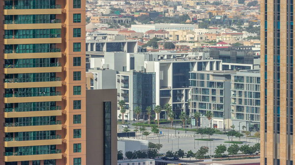 City Walk district aerial timelapse, new urban area near Dubai downtown. Residential buildings and shopping zone behind skyscraper