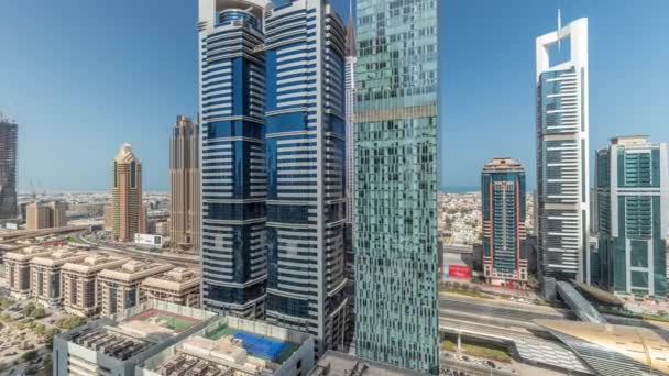 Panorama showing aerial view of Dubai International Financial District with many skyscrapers timelapse. — Stock Video
