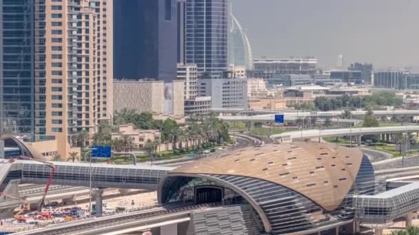 Futuristic building of Dubai metro station and luxury skyscrapers back in Dubai Marina air timelapse, United Arab Emirates — стокове відео