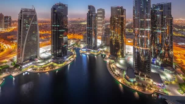 Tall residential buildings at JLT aerial night to day timelapse, part of the Dubai multi commodities centre mixed-use district. — Stock Video