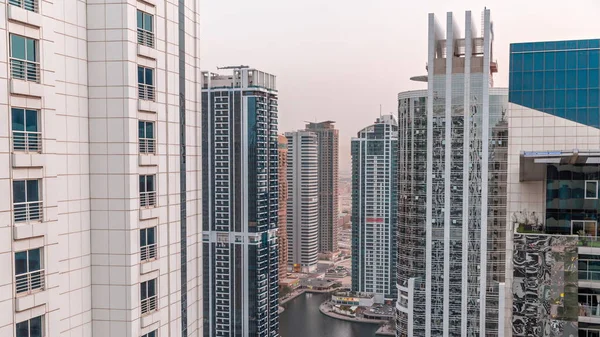 Tall residential buildings at JLT aerial day to night timelapse, part of the Dubai multi commodities centre mixed-use district. — Stock Photo, Image