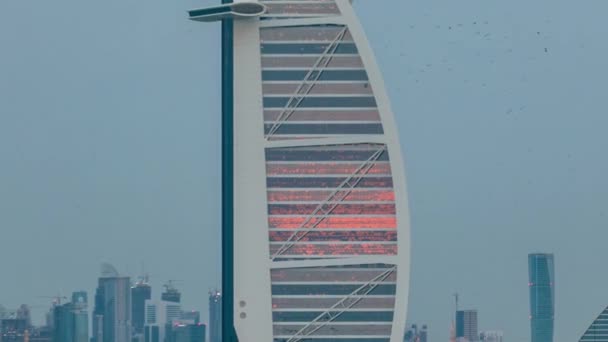 Dubai skyline with Burj Al Arab hotel during sunset and day to night timelapse. — Stock Video