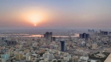Sunrise with the city scape of Ajman from roof airial time.