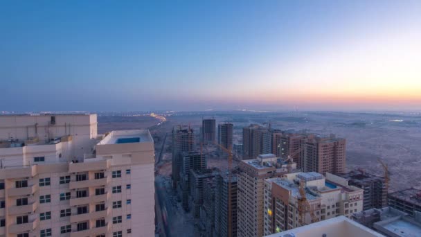 Cityscape of Ajman from rooftop before sunrise night to day timelapse. United Arab Emirates. — Stock Video