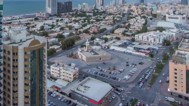 Cityscape with towers in Ajman from rooftop day to night timelapse. United Arab Emirates. — Stock Video