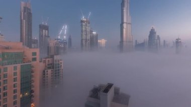 Dubai şehrinin hava görüntüsü sabahın erken saatlerinde sisli geceden gündüze.