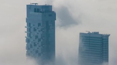 Güneş doğarken Şeyh Zayed Yolu yakınlarındaki JLT gökdelenleri ve marina kulelerini sis kapladı. Konut binaları