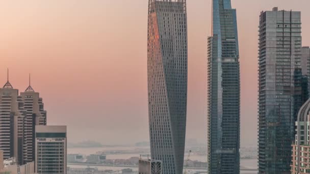 Небоскрёбы Дубайской пристани рядом с перекрестком на Шейх-Заид-роуд с высокими жилыми зданиями изо дня в день — стоковое видео