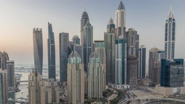 Skyscrapers of Dubai Marina near intersection on Sheikh Zayed Road with highest residential buildings day to night timelapse — Stock Video