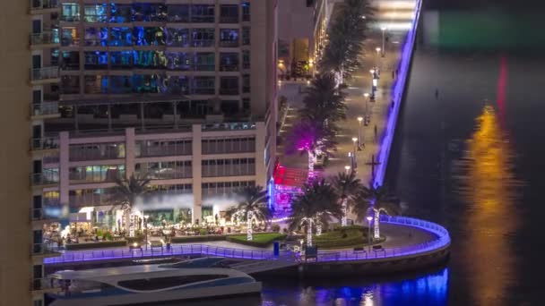 Promenade and canal in Dubai Marina with luxury skyscrapers around night timelapse, United Arab Emirates — Stock Video