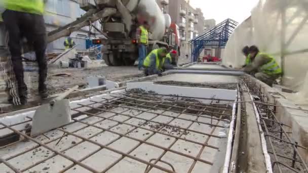 Pouring ready-mixed concrete after placing steel reinforcement to make the road by concrete mixer timelapse hyperlapse. — Stock Video