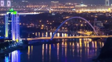 Nehir ve ışıklı köprü timelapse Astana gece çatı üzerinden. Kazakistan başkenti