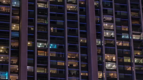 Grandes janelas brilhantes em escritórios modernos e edifícios residenciais timelapse à noite — Vídeo de Stock