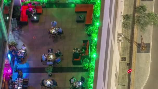 Outdoor terrace with tables and chairs in restaurant aerial top view night timelapse — Stock Video