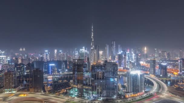 Panoramic skyline of Dubai with business bay and downtown district all night timelapse. — Stock Video