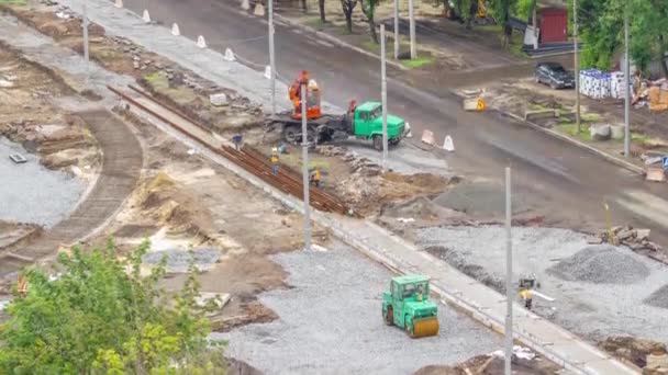 Orange construction telescopic mobile crane unloading tram rails aerial timelapse. — ストック動画