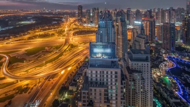 Dubai marina and JLT skyscrapers along Sheikh Zayed Road aerial night to day timelapse. — Stock Video