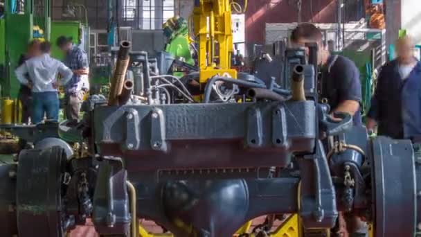 Conveyor assembly stage the body of tractor at big industrial factory timelapse — Stock Video