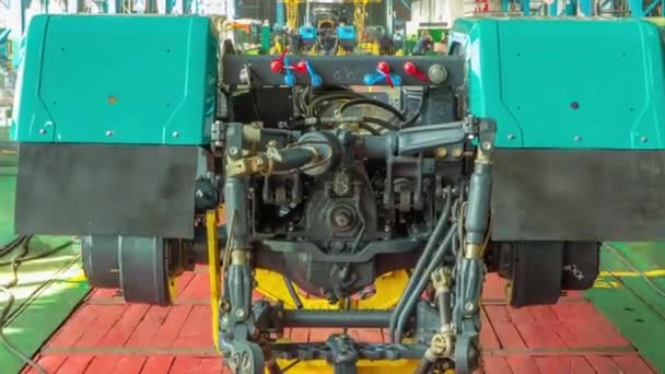 Conveyor assembly stage the body of tractor at big industrial factory timelapse — Stock Video