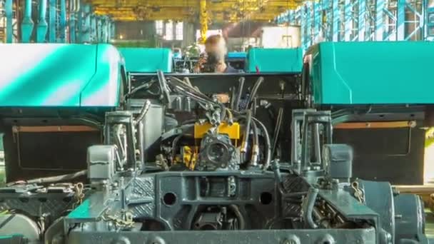 Conveyor assembly stage the body of tractor at big industrial factory timelapse — Stock Video