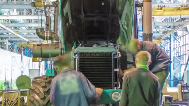 Conveyor assembly stage the body of tractor at big industrial factory timelapse — Stock Video