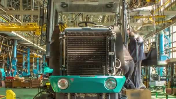 Conveyor assembly stage the body of tractor at big industrial factory timelapse — Stock Video