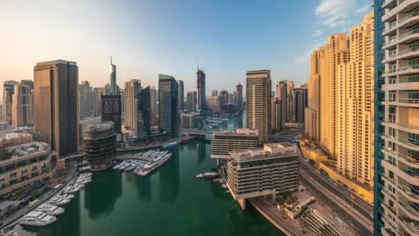 Aerial view to Dubai marina skyscrapers around canal with floating boats timelapse — Stock Video