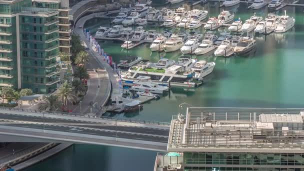 Aerial view to Dubai marina skyscrapers around canal with floating boats timelapse — Stock Video