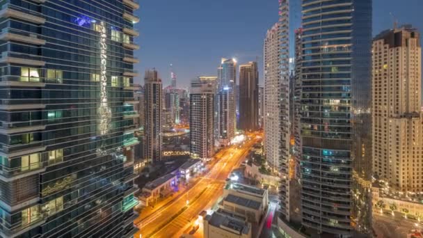 View of the Dubai Marina and JBR area and the famous Ferris Wheel aerial night to day timelapse — Stock Video