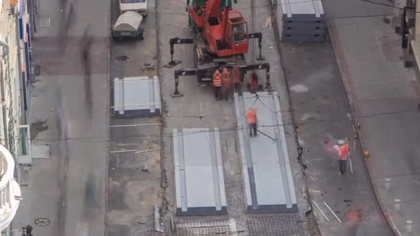 Instalace betonových desek pomocí jeřábu na silnici stavební lokality timelapse. — Stock video