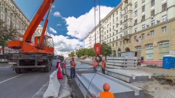 Установка бетонных плит с помощью крана на месте строительства дорог . — стоковое видео