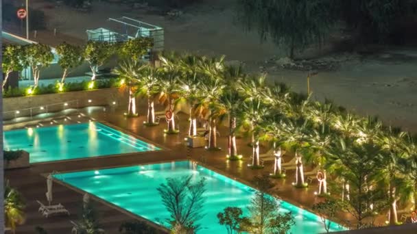 Luxury outdoor swimming pool and relaxing zone around aerial timelapse — Stock Video