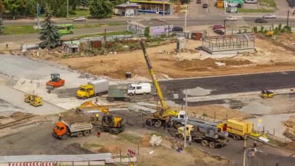 Aerial view of large road construction site with several industrial machines timelapse. — Video