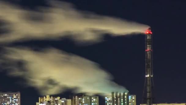 Pipes with smoke and residential apartment buildings night timelapse. — Stockvideo
