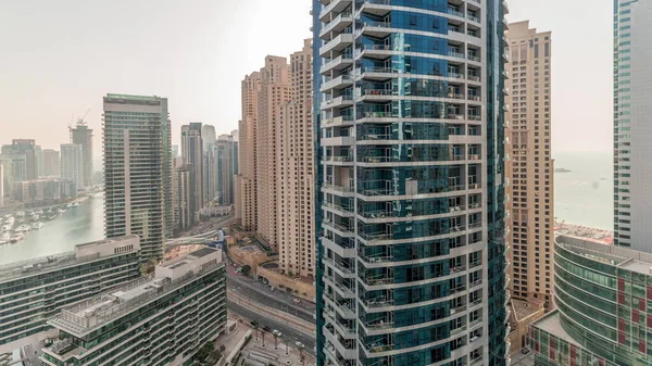 Panorama, JBR ve Dubai Marina gökdelenlerinin gökdelenlerinin gökdelenlerini gösteriyor. Kanal suyunda yüzen yatlar. Arka planda JLT bölgesi