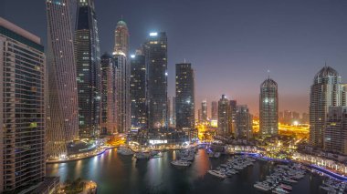 Dubai marinası en uzun gökdelenler ve yatlar liman havasında gece gündüz geçiş zamanları gün doğumunda. Apartman binalarına, otellere ve ofis bloklarına, BAE 'nin modern yerleşim alanlarına bak