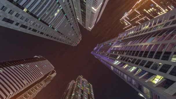 Look up to the night sky with tallest skyscrapers with illuminated windows — Stock Video