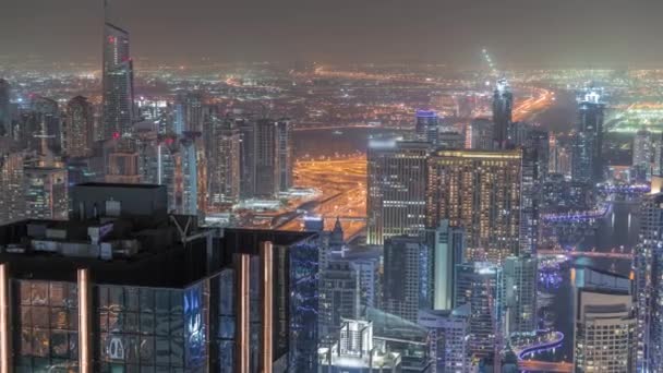 Dubai Marina y el distrito JLT con tráfico en carretera entre rascacielos de noche aérea timelapse. — Vídeo de stock