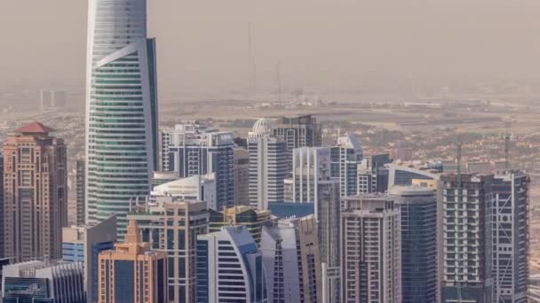 Jumeirah Lakes Towers district with many skyscrapers along Sheikh Zayed Road aerial timelapse. — Stock Video