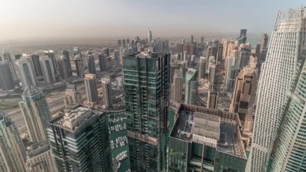 Panorama showing Dubai Marina and JLT with JBR district. Ttraffic on highway between skyscrapers aerial timelapse. — Stock Video