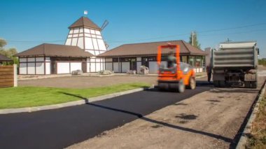 Yol yapımı ve tamir işleri sırasında asfalt kaldırım makinesi kullanan işçiler