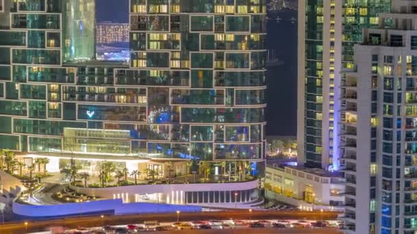 Modern skyscrapers in Dubai Marina, close up view to many illuminated windows aerial night timelapse. — Stock Video