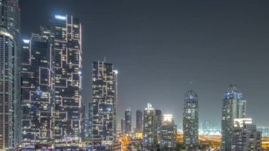 Şehirde lüks yat körfezi Dubai marinasında havadan gece saatleri.