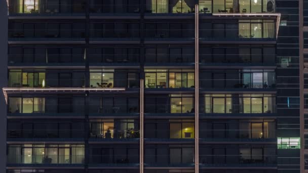 Flat night panorama of multicolor light in windows of multistory buildings aerial timelapse. — Stockvideo