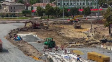 Excavator working on earthmoving at open pit mining in the city street timelapse.