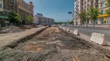 Excavator working on earthmoving at open pit mining in the city street timelapse.