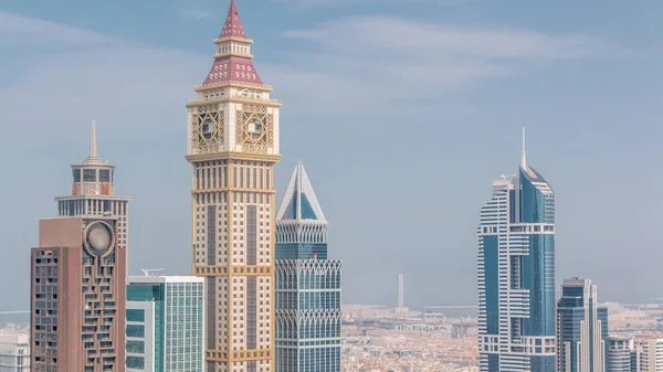 stock image Skyscrapers on Sheikh Zayed Road and DIFC timelapse in Dubai, UAE. Towers in financial centre aerial view from above. Blue sky. Port on a background