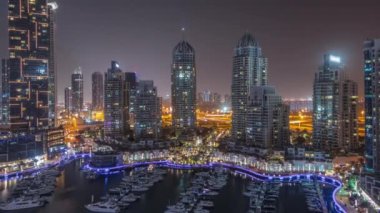 Dubai marinasında gece boyu şehir havasında lüks yat hangarı.