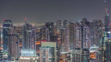 Dubai marinası ve JLT, Sheikh Zayed Yolu üzerindeki gökdelenleri aydınlattı. Gökyüzünden yanıp sönen ışıkları olan birçok konut ve ofis binası.